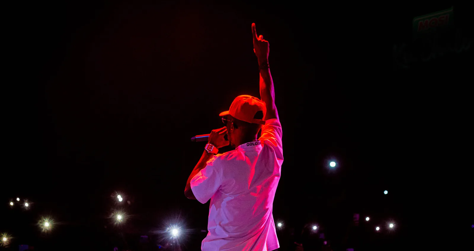 A performer on stage during a live event photographed by True Virtue Media